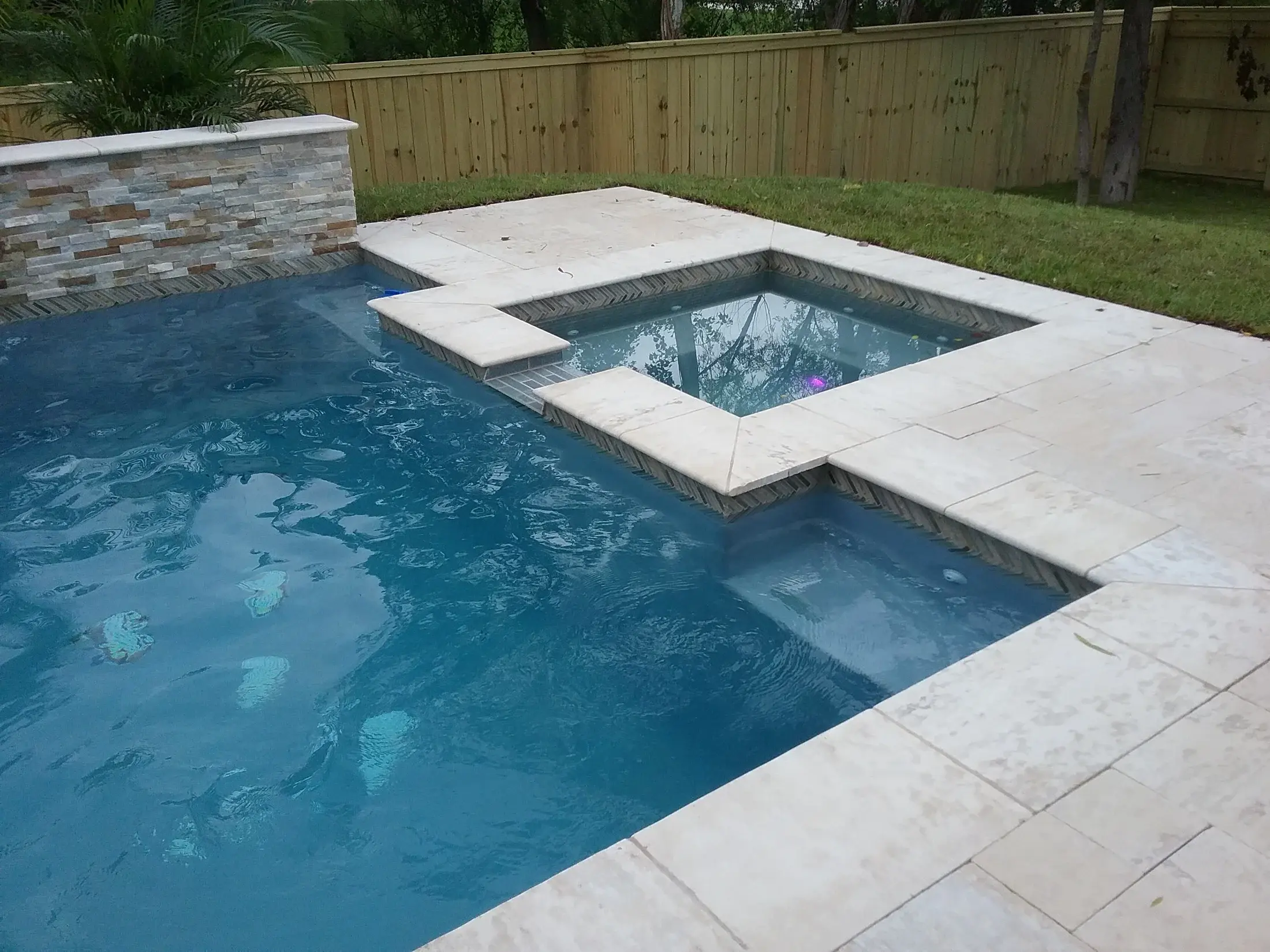 Custom spa and swimming pool built by Clearwater Outdoor Creations
