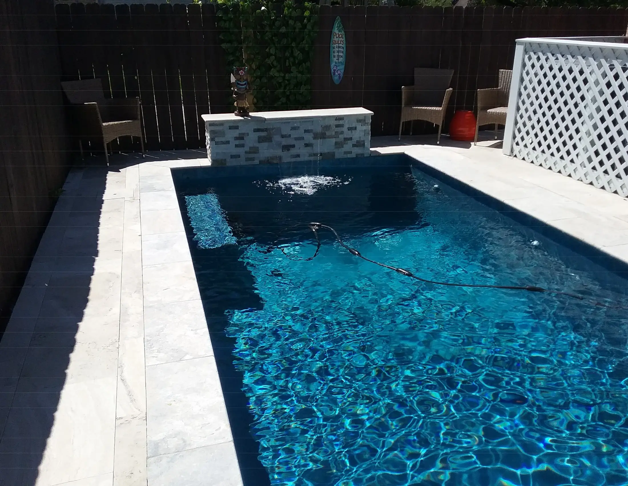Clearwater custom pool with an accent wall and water features