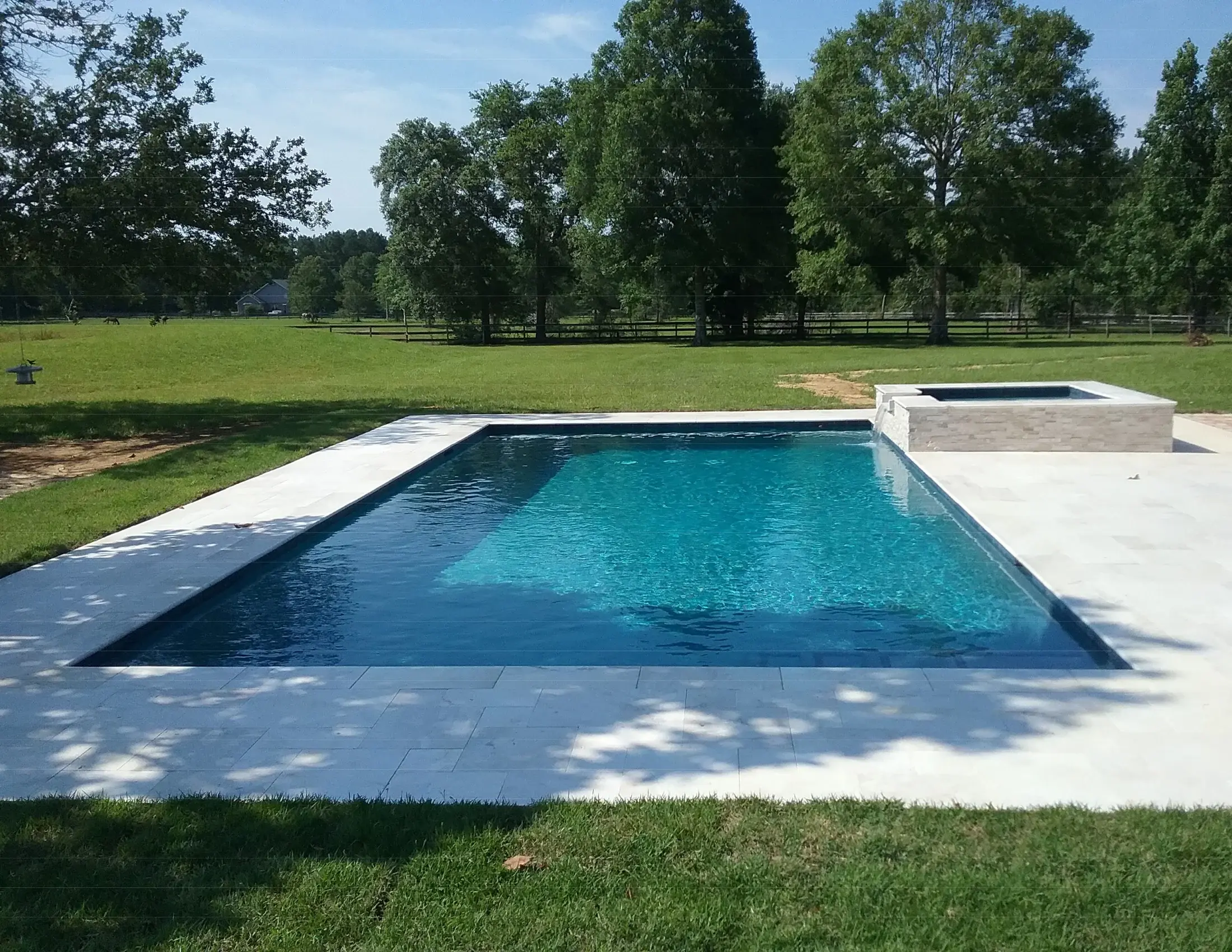 Clearwater geometric custom swimming pool and surrounding terrace